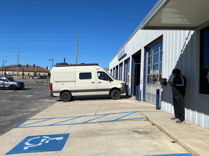 A Sprinter van pulled up to the A&A Glass service bay with a customer at the door