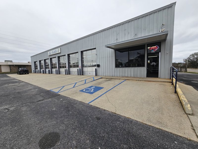 The full A&A Glass building with its row of service bays and the OPEN sign